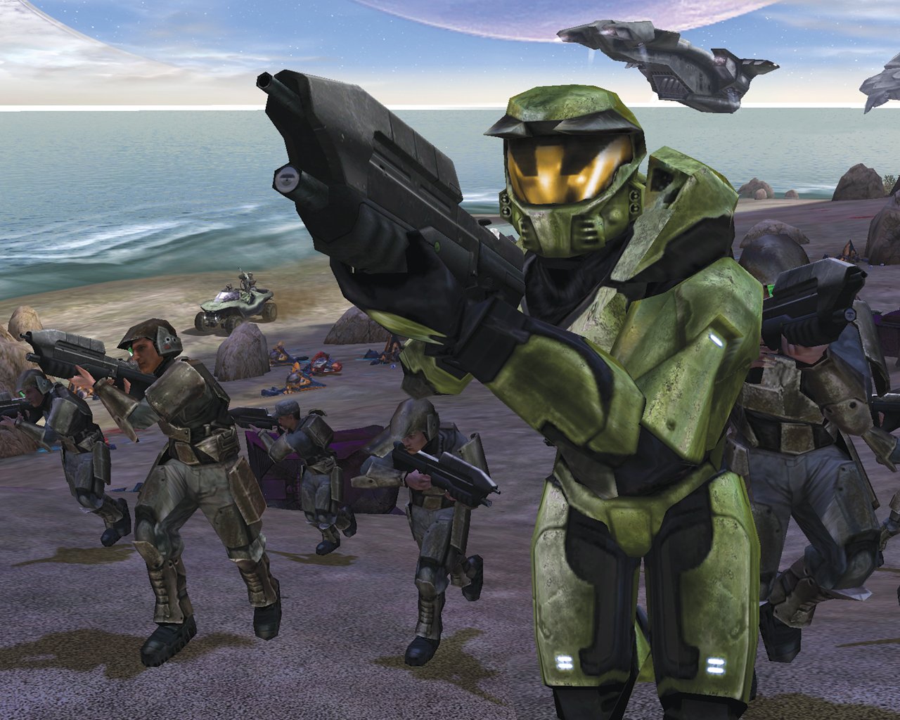 The Master Chief in green armour leading marines up a beach. In the background is a Warthog, dead enemies, and a Pelican.