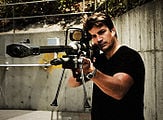 Fillion posing with a rifle.