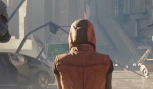 A crop of Agryna walking towards a sign that reads Heathrow Spaceport.