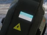 A "high voltage" warning sticker placed on the back of the M6/X.