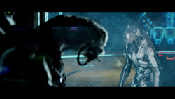 Arbiter Thel 'Vadamee confronts Sesa 'Refumee, who has sealed himself behind a shield door.