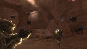 Members of NOBLE Team (Emile-A239 and SPARTAN-B312) fighting a swarm of Yanme'e in caverns near Asźod ship breaking yards during Battle of Asźod. From Halo: Reach campaign level The Pillar of Autumn.
