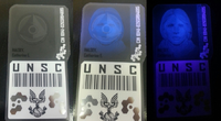Halsey's ID badge under natural light, partial black light, and total black light.