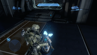 Campaign third-person view of John-117 with a detached plasma cannon in Ivanoff Station.