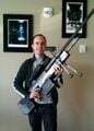 Journalist Stephen Totilo holding the sniper rifle prop, after Bungie's headquarters were investigated by the police.