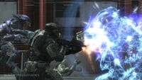 A Spartan breaks a Sangheili's energy shields.