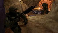 The Master Chief throwing a Firebomb grenade at a Flood tank form.