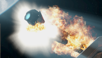 A Strident-class frigate erupts in flames.