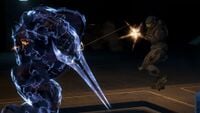 Noble Six fires his assault rifle at a Sangheili Zealot inside the outpost.