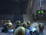 The Master Chief watches as Pod infectors prepare to consume a dead Elite and a dead Grunt.