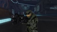 John-117 wielding a shotgun in the lower floors of the index chamber.
