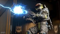 A Spartan clad in Hazmat firing a shock rifle.
